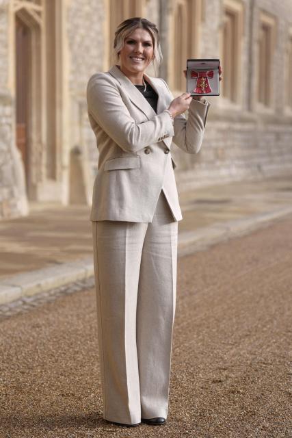 Chelsea's English defender Millie Bright poses with their medal after being appointed an Officer of the Order of the British Empire (OBE) at an investiture ceremony at Windsor Castle, in Windsor on January 14, 2026. (Photo by Andrew Matthews / POOL / AFP)