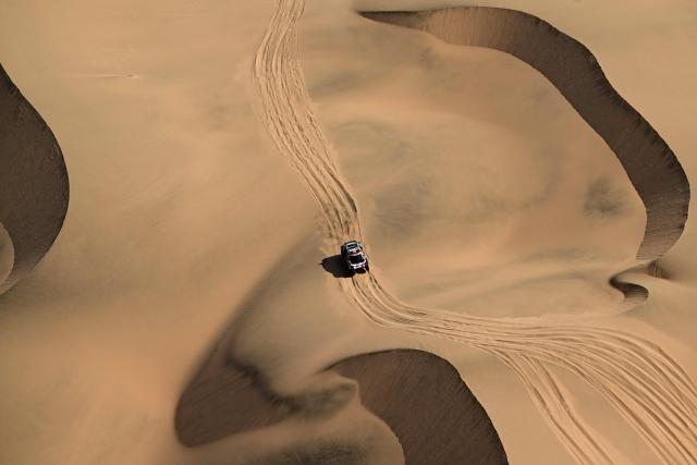 TOPSHOT - The Dacia Sandriders’s French driver Sebastien Loeb and French co-pilot Edouard Boulanger compete in Stage 10 of the 48th edition of the Dakar Rally 2026, between Bisha and Bisha, Saudi Arabia, on January 14, 2026. (Photo by Giuseppe CACACE / AFP)