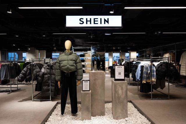 (FILES) This photograph shows the logo of Asian e-commerce giant Shein in its stall at the Bazar de l'Hotel de Ville (BHV) department store in Paris on November 4, 2025, on the eve of the opening of its first physical store at BHV in Paris. Shein has an appointment on January 21, 2026 before the Senate Economic Affairs Committee and is expected to attend this time, his spokesperson France told AFP on January 14, 2026. Shein declined several appointments before the National Assembly in November and December 2026, citing ongoing legal proceedings regarding the request to suspend its website after the sale of prohibited products. (Photo by Julie SEBADELHA / AFP)