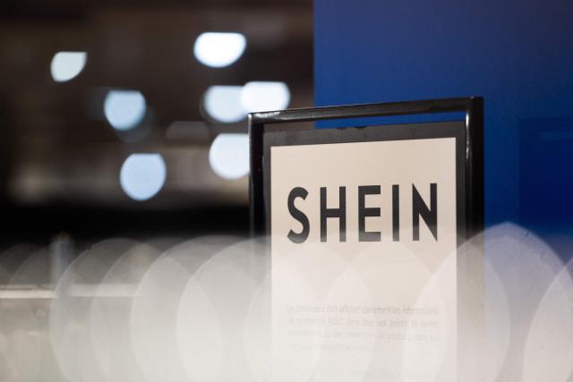 (FILES) This photograph shows the logo of Asian e-commerce giant Shein in its stall at the Bazar de l'Hotel de Ville (BHV) department store in Paris on November 4, 2025. Shein has an appointment on January 21, 2026 before the Senate Economic Affairs Committee and is expected to attend this time, his spokesperson France told AFP on January 14, 2026. Shein declined several appointments before the National Assembly in November and December 2026, citing ongoing legal proceedings regarding the request to suspend its website after the sale of prohibited products. (Photo by Julie SEBADELHA / AFP)