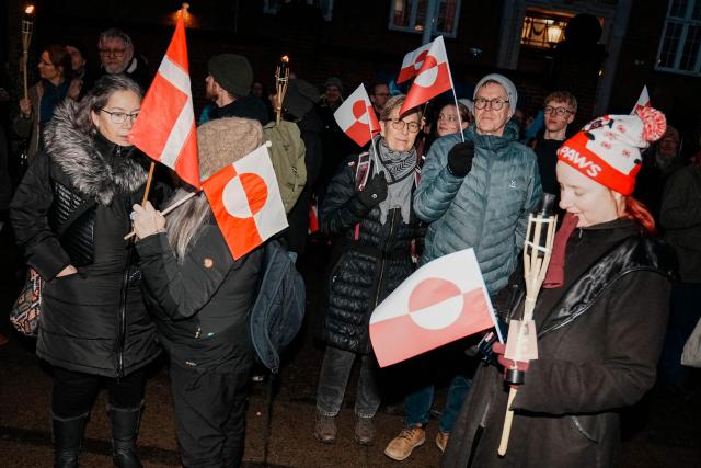 Protestors with Greenlandic flags attend a demonstration under the motto "Greenland is for Greenlanders" in front of the embassy in Copenhagen on January 14, 2026. Denmark will beef up its military presence in Greenland "from today", the defence ministry said, just before high-stakes talks were to start in Washington over US President Donald Trump's threats to take over the Arctic island. (Photo by Thomas Traasdahl / Ritzau Scanpix / AFP) / Denmark OUT