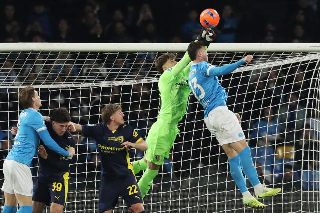 Napoli's Uruguayan defender #17 Mathias Olivera jumps for the ball with Parma's Italian goalkeeper #66 Filippo Rinaldi during the Italian Serie A football match between Napoli and Parma at the Diego Armando Maradona Stadium in Naples on January 14, 2026. (Photo by CARLO HERMANN / AFP)