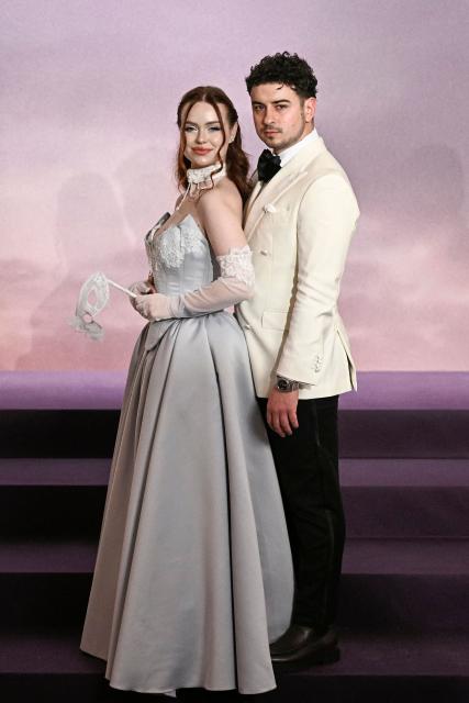 Romanian content creator Lorena Dumitru (L) and Sebastian Dumitru (R) arrive for the World premiere of "Bridgerton Season 4" at the Palais Brongniart in Paris on January 14, 2026. (Photo by JULIEN DE ROSA / AFP)