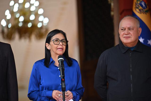 Venezuela's interim President Delcy Rodriguez (L) speaks next to Minister of the Popular Power for Interior Diosdado Cabello during a press conference at the Miraflores Presidential Palace in Caracas on January 14, 2026. Venezuela's interim president Delcy Rodriguez said on January 14, that her country was looking to "a new political era" after the January 3 ouster of leader Nicolas Maduro in a US military strike. (Photo by Juan BARRETO / AFP)