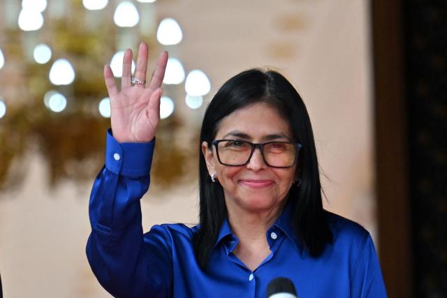 Venezuela's interim President Delcy Rodriguez waves after a press conference at the Miraflores Presidential Palace in Caracas on January 14, 2026. Venezuela has freed 15 journalists, including a leading opposition figure, as the slow release of political prisoners begun after Nicolas Maduro's ouster continues, activists said on January 14. (Photo by Juan BARRETO / AFP)
