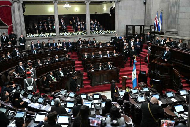 Guatemala's President Bernardo Arevalo (R) speaks during the official report of his second year as head of state at the National Congress in Guatemala City on January 14, 2026. (Photo by JOHAN ORDONEZ / AFP)