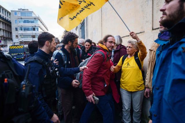 A French police officer drags a protester during a demonstration called by the Confederation Paysanne farmers union against the EU-Mercosur trade deal in front of the Ministry of Agriculture in Paris on January 14, 2026. (Photo by Dimitar DILKOFF / AFP)
