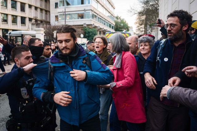 A French police officer drags a protester during a demonstration called by the Confederation Paysanne farmers union against the EU-Mercosur trade deal in front of the Ministry of Agriculture in Paris on January 14, 2026. (Photo by Dimitar DILKOFF / AFP)
