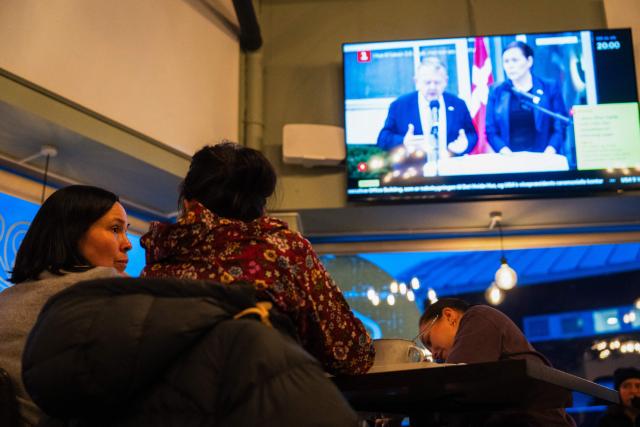 People watch a press conference of Greenland's Foreign Minister Vivian Motzfeldt and Denmark's Foreign Minister Lars Loekke Rasmussen on TV in a restaurant on January 14, 2026 in Nuuk, Greenland, after a meeting over the future of the island is being held in Washington. Independent UN experts on on January 14, 2026 expressed "grave concern" over US President Donald Trump's desire to take control of Greenland, a move they likened to "colonial domination". (Photo by Alessandro RAMPAZZO / AFP)
