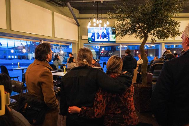 People watch a a press conference on TV in a restaurant on January 14, 2026 in Nuuk, Greenland, after a meeting over the future of the island is being held in Washington. Independent UN experts on on January 14, 2026 expressed "grave concern" over US President Donald Trump's desire to take control of Greenland, a move they likened to "colonial domination". (Photo by Alessandro RAMPAZZO / AFP)