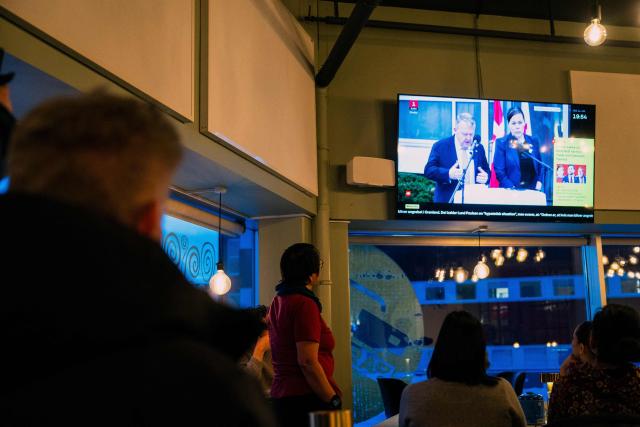 People watch a press conference of Greenland's Foreign Minister Vivian Motzfeldt and Denmark's Foreign Minister Lars Loekke Rasmussen on TV in a restaurant on January 14, 2026 in Nuuk, Greenland, after a meeting over the future of the island is being held in Washington. Independent UN experts on on January 14, 2026 expressed "grave concern" over US President Donald Trump's desire to take control of Greenland, a move they likened to "colonial domination". (Photo by Alessandro RAMPAZZO / AFP)