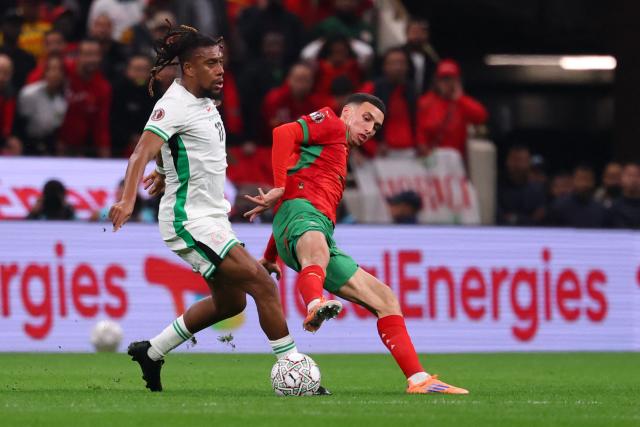 Nigeria's forward #17 Alex Iwobi fights for the ball with  Morocco's midfielder #23 Bilal El Khannouss during the Africa Cup of Nations (CAN) semi-final football match between Nigeria and Morocco at the Prince Moulay Abdellah stadium in Rabat on January 14, 2026. (Photo by FRANCK FIFE / AFP)