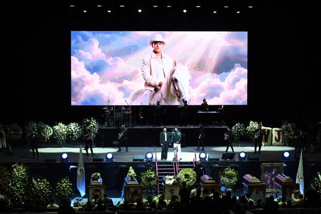 This view shows a photograph of Colombian singer Yeison Jimenez on a big screen during his funeral honors in Bogota on January 14, 2026. Six people died on january 10, including popular singer Yeison Jimenez, when the small plane they were traveling in crashed shortly after takeoff in central Colombia, authorities said. (Photo by Raul ARBOLEDA / AFP)