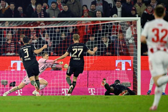 FC Cologne's German midfielder #37 Linton Maina (hidden R) scores the opening goal wpast Bayern Munich's German goalkeeper #01 Manuel Neuer during the German first division Bundesliga football match between FC Cologne and FC Bayern Munich in Cologne, western Germany on January 14, 2026. (Photo by INA FASSBENDER / AFP) / DFL REGULATIONS PROHIBIT ANY USE OF PHOTOGRAPHS AS IMAGE SEQUENCES AND/OR QUASI-VIDEO
