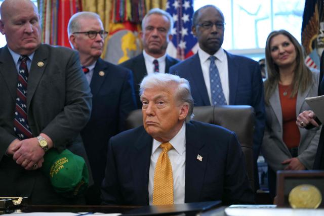 US President Donald Trump looks on before signing a bill in the Oval Office of the White House in Washington, DC, on January 14, 2026. (Photo by Brendan SMIALOWSKI / AFP)