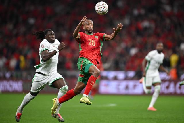 TOPSHOT - Nigeria's defender #21 Calvin Bassey and Morocco's forward #20 Ayoub El Kaabi vie during the Africa Cup of Nations (CAN) semi-final football match between Nigeria and Morocco at the Prince Moulay Abdellah stadium in Rabat on January 14, 2026. (Photo by Paul ELLIS / AFP)