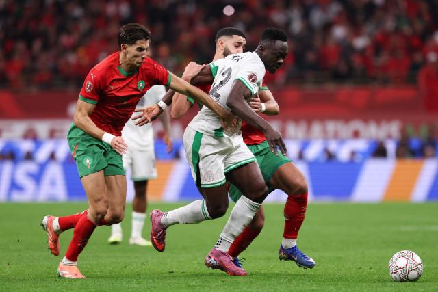 (From L) Morocco's defender #05 Nayef Aguerd, Nigeria's forward #22 Akor Adams and Morocco's midfielder #11 Ismael Saibari fight for the ball during the Africa Cup of Nations (CAN) semi-final football match between Nigeria and Morocco at the Prince Moulay Abdellah stadium in Rabat on January 14, 2026. (Photo by FRANCK FIFE / AFP)