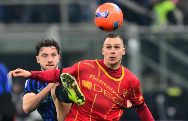 Inter Milan's Brazilian defender #30 Carlos Augusto (L) and Lecce's Montenegrin forward #09 Nikola Krstovic (R) fight for the ball during the Italian Serie A football match between Inter Milan and Lecce at the San Siro stadium in Milan, on January 14, 2026. (Photo by Stefano RELLANDINI / AFP)