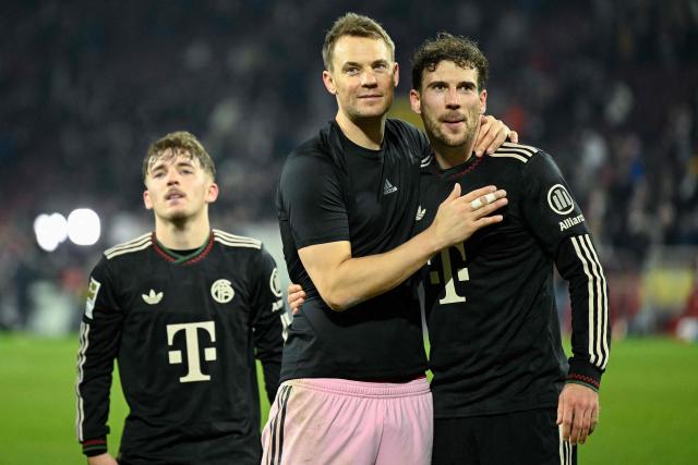 Bayern Munich's German goalkeeper #01 Manuel Neuer, Bayern Munich's German midfielder #08 Leon Goretzka (R) and Bayern Munich's German midfielder #42 Lennart Karl celebrate after the German first division Bundesliga football match between FC Cologne and FC Bayern Munich in Cologne, western Germany on January 14, 2026. (Photo by INA FASSBENDER / AFP) / DFL REGULATIONS PROHIBIT ANY USE OF PHOTOGRAPHS AS IMAGE SEQUENCES AND/OR QUASI-VIDEO