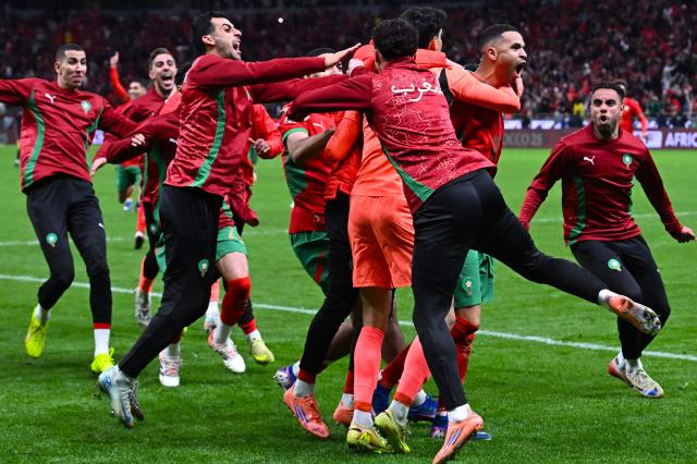 Morocco's players celebrate after winning the Africa Cup of Nations (CAN) semi-final football match between Nigeria and Morocco at the Prince Moulay Abdellah stadium in Rabat on January 14, 2026. (Photo by Paul ELLIS / AFP)