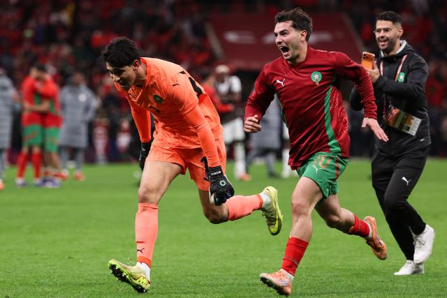 Morocco's goalkeeper #01 Yassine Bounou and Morocco's forward #10 Brahim Diaz celebrate after winning the Africa Cup of Nations (CAN) semi-final football match between Nigeria and Morocco at the Prince Moulay Abdellah stadium in Rabat on January 14, 2026. (Photo by FRANCK FIFE / AFP)