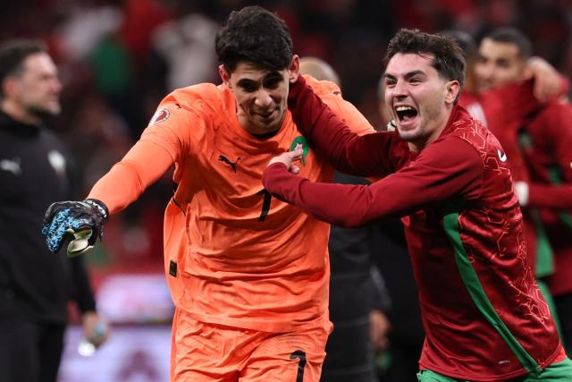 Morocco's goalkeeper #01 Yassine Bounou and Morocco's forward #10 Brahim Diaz celebrate after winning the Africa Cup of Nations (CAN) semi-final football match between Nigeria and Morocco at the Prince Moulay Abdellah stadium in Rabat on January 14, 2026. (Photo by FRANCK FIFE / AFP)
