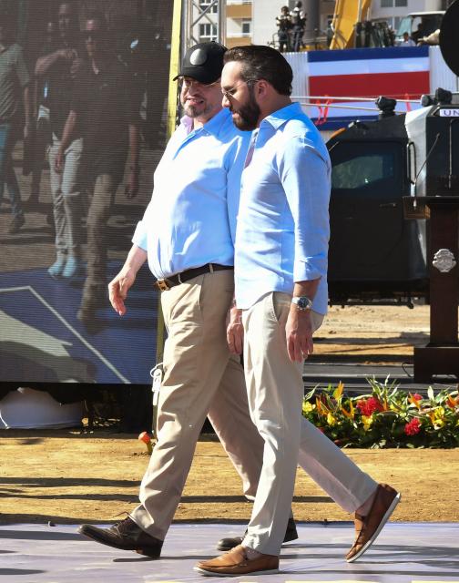Costa Rica's President Rodrigo Chaves (L) and El Salvador's President Nayib Bukele leave after a press conference at the construction site of the High Containment Center for Organized Crime (CACO) prison in Alajuela, Costa Rica on January 14, 2026. (Photo by EZEQUIEL BECERRA / AFP)