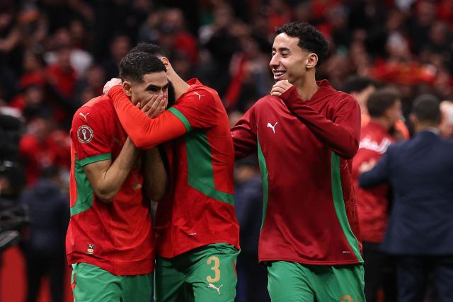 Morocco's defender #02 Achraf Hakimi celebrates with teammates after winning the Africa Cup of Nations (CAN) semi-final football match between Nigeria and Morocco at the Prince Moulay Abdellah stadium in Rabat on January 14, 2026. (Photo by FRANCK FIFE / AFP)