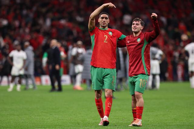 Morocco's defender #02 Achraf Hakimi and Morocco's forward #10 Brahim Diaz celebrate after winning the Africa Cup of Nations (CAN) semi-final football match between Nigeria and Morocco at the Prince Moulay Abdellah stadium in Rabat on January 14, 2026. (Photo by FRANCK FIFE / AFP)