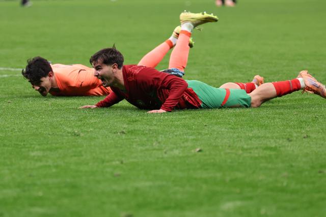 Morocco's goalkeeper #01 Yassine Bounou and Morocco's forward #10 Brahim Diaz celebrate after winning the Africa Cup of Nations (CAN) semi-final football match between Nigeria and Morocco at the Prince Moulay Abdellah stadium in Rabat on January 14, 2026. (Photo by FRANCK FIFE / AFP)
