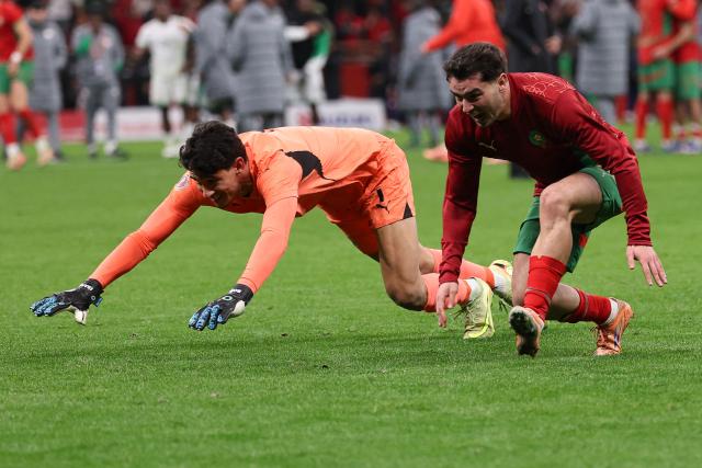 Morocco's goalkeeper #01 Yassine Bounou and Morocco's forward #10 Brahim Diaz celebrate after winning the Africa Cup of Nations (CAN) semi-final football match between Nigeria and Morocco at the Prince Moulay Abdellah stadium in Rabat on January 14, 2026. (Photo by FRANCK FIFE / AFP)