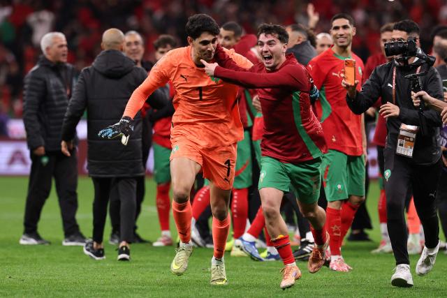 Morocco's goalkeeper #01 Yassine Bounou and Morocco's forward #10 Brahim Diaz celebrate after winning the Africa Cup of Nations (CAN) semi-final football match between Nigeria and Morocco at the Prince Moulay Abdellah stadium in Rabat on January 14, 2026. (Photo by FRANCK FIFE / AFP)