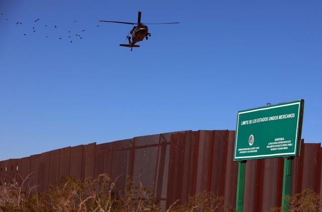 An US Air and Marine Operations (AMO) helicopter patrols the US-Mexico border at Santa Teresa, New Mexico, US, as seen from Ciudad Juarez, Chihuahua state, Mexico on January 14, 2026. (Photo by Herika Martinez / AFP)