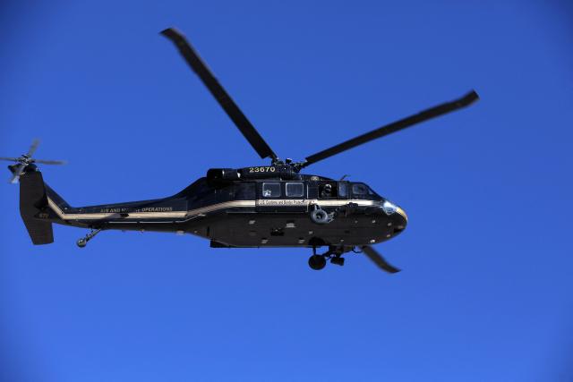 An US Air and Marine Operations (AMO) helicopter patrols the US-Mexico border at Santa Teresa, New Mexico, US, as seen from Ciudad Juarez, Chihuahua state, Mexico on January 14, 2026. (Photo by Herika Martinez / AFP)
