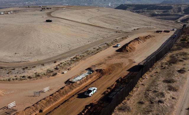 Aerial view of an US Border Patrol pickup bext to the wall being constructed at the US-Mexico border in Santa Teresa, New Mexico, US, as seen from Ciudad Juarez, Chihuahua state, Mexico on January 14, 2026. (Photo by Herika Martinez / AFP)