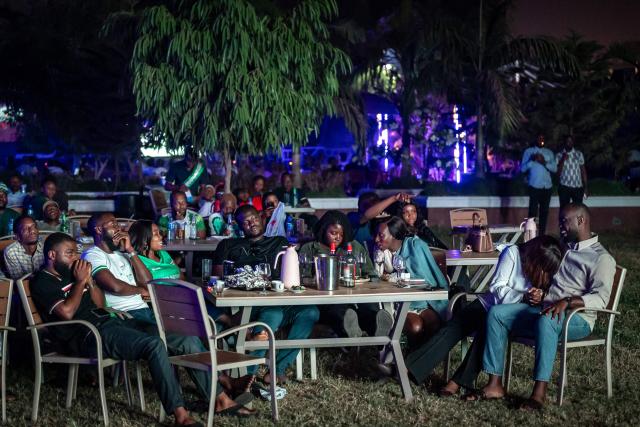 Nigeria football fans react as they watch the Africa Cup of Nations (CAN) semi-final football match between Nigeria and Morocco on a large screen at an outdoor bar in Abuja on January 14, 2026. (Photo by Light Oriye / AFP)