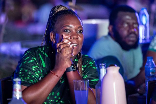 Nigeria football fans watch the Africa Cup of Nations (CAN) semi-final football match between Nigeria and Morocco on a large screen at an outdoor bar in Abuja on January 14, 2026. (Photo by Light Oriye / AFP)