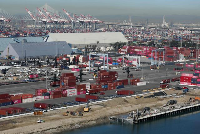 Top loaders move cargo shipping containers as construction crews work on Pier G South Slip Fill project as seen from a crane on the ITS Terminal at the Port of Long Beach in Long Beach, California on January 14, 2026. (Photo by Patrick T. Fallon / AFP)
