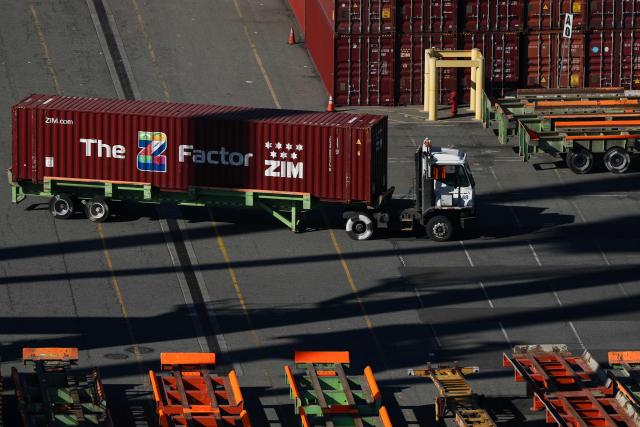 A truck moves a cargo shipping container as seen from a crane above the ITS Terminal at the Port of Long Beach in Long Beach, California on January 14, 2026. (Photo by Patrick T. Fallon / AFP)