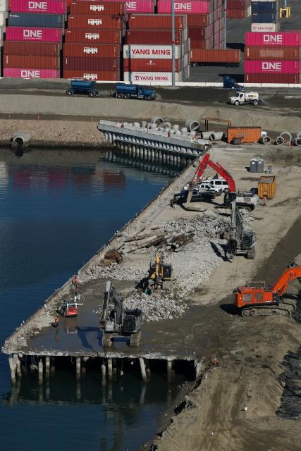 A construction crew works on the Pier G South Slip Fill project as seen from a crane on the ITS Terminal at the Port of Long Beach in Long Beach, California on January 14, 2026. (Photo by Patrick T. Fallon / AFP)