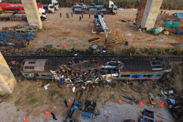 An aerial view shows the wreckage of a train that crashed when a construction crane collapsed the day before, in Thailand's Nakhon Ratchasima province on January 15, 2026. (Photo by Lillian SUWANRUMPHA / AFP)