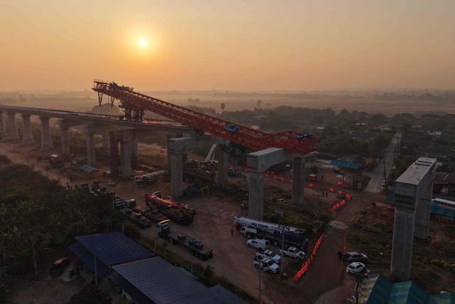 An aerial view shows the wreckage of a train that crashed when a construction crane collapsed the day before, in Thailand's Nakhon Ratchasima province on January 15, 2026. (Photo by Lillian SUWANRUMPHA / AFP)