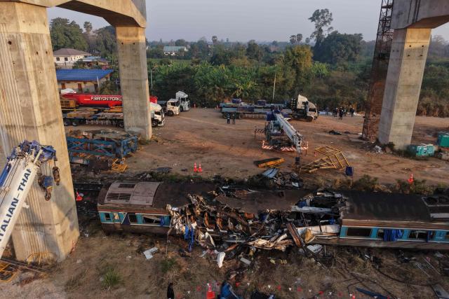 An aerial view shows the wreckage of a train that crashed when a construction crane collapsed the day before, in Thailand's Nakhon Ratchasima province on January 15, 2026. (Photo by Lillian SUWANRUMPHA / AFP)