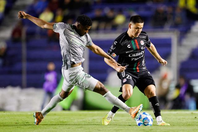 America's Colombian forward #19 Jose Raul Zuniga (L) and San Luis' midfielder #21 Oscar Macias fight for the ball during the Liga MX Clausura tournament football match between America and San Luis at the Azteca Stadium in Mexico City on January 14, 2026. (Photo by Rodrigo Oropeza / AFP)