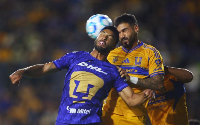 Pumas' Brazilian defender #06 Nathan Silva and Tigres' defender #04 Juan Jose Purata fight for the ball during the Liga MX Clausura tournament football match between Tigres and Pumas at the University  Stadium (UANL) in San Nicolas de los Garza, Mexico on January 14, 2026. (Photo by Julio Cesar AGUILAR / AFP)