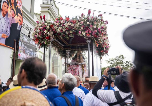 Faithfuls carry an effigy of Divina Pastora during its annual procession in Barquisimeto, Venezuela on January 14, 2026. (Photo by Maryorin Mendez / AFP)
