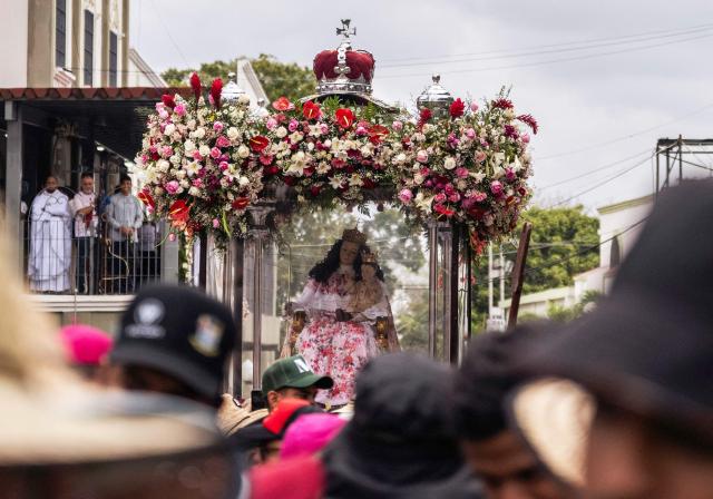 Faithfuls carry an effigy of Divina Pastora during its annual procession in Barquisimeto, Venezuela on January 14, 2026. (Photo by Maryorin Mendez / AFP)