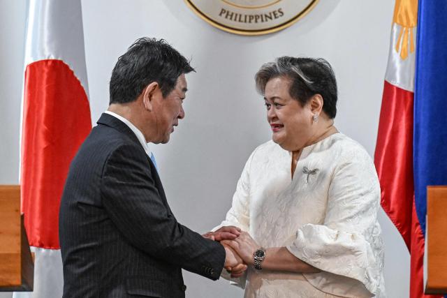 Japan's Foreign Minister Toshimitsu Motegi (L) shakes hands with Philippines' Foreign Minister Theresa Lazaro after a joint press conference in Pasay, Metro Manila on January 15, 2026. (Photo by Jam STA ROSA / AFP)