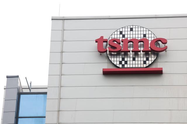 (FILES) The logo of Taiwan Semiconductor Manufacturing Company (TSMC) is seen at its headquarters in Hsinchu on November 21, 2024. Taiwanese chipmaking titan TSMC announced on January 15, 2026 a forecast-busting net profit for the fourth quarter as demand for AI technology skyrockets. (Photo by I-Hwa CHENG / AFP)