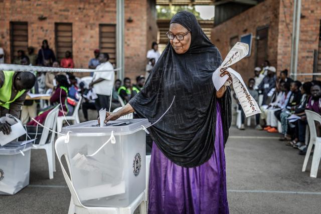 TOPSHOT - A voter casts her ballot at a school used as a polling station in Kampala on January 15, 2026, during Uganda’s 2026 general elections. (Photo by Luis TATO / AFP)